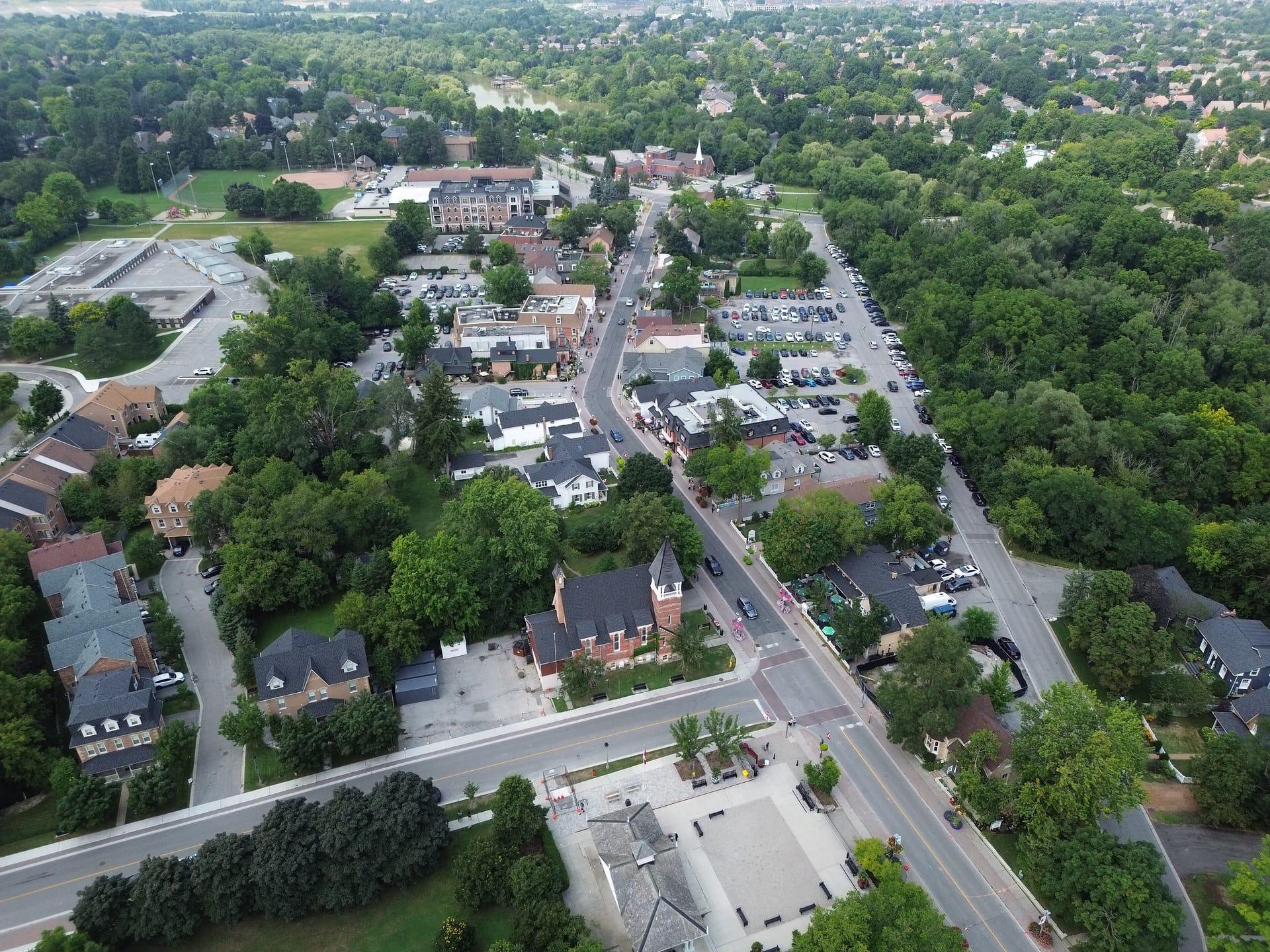 Main Street Unionville from the air, lined with trees and low historic buildings