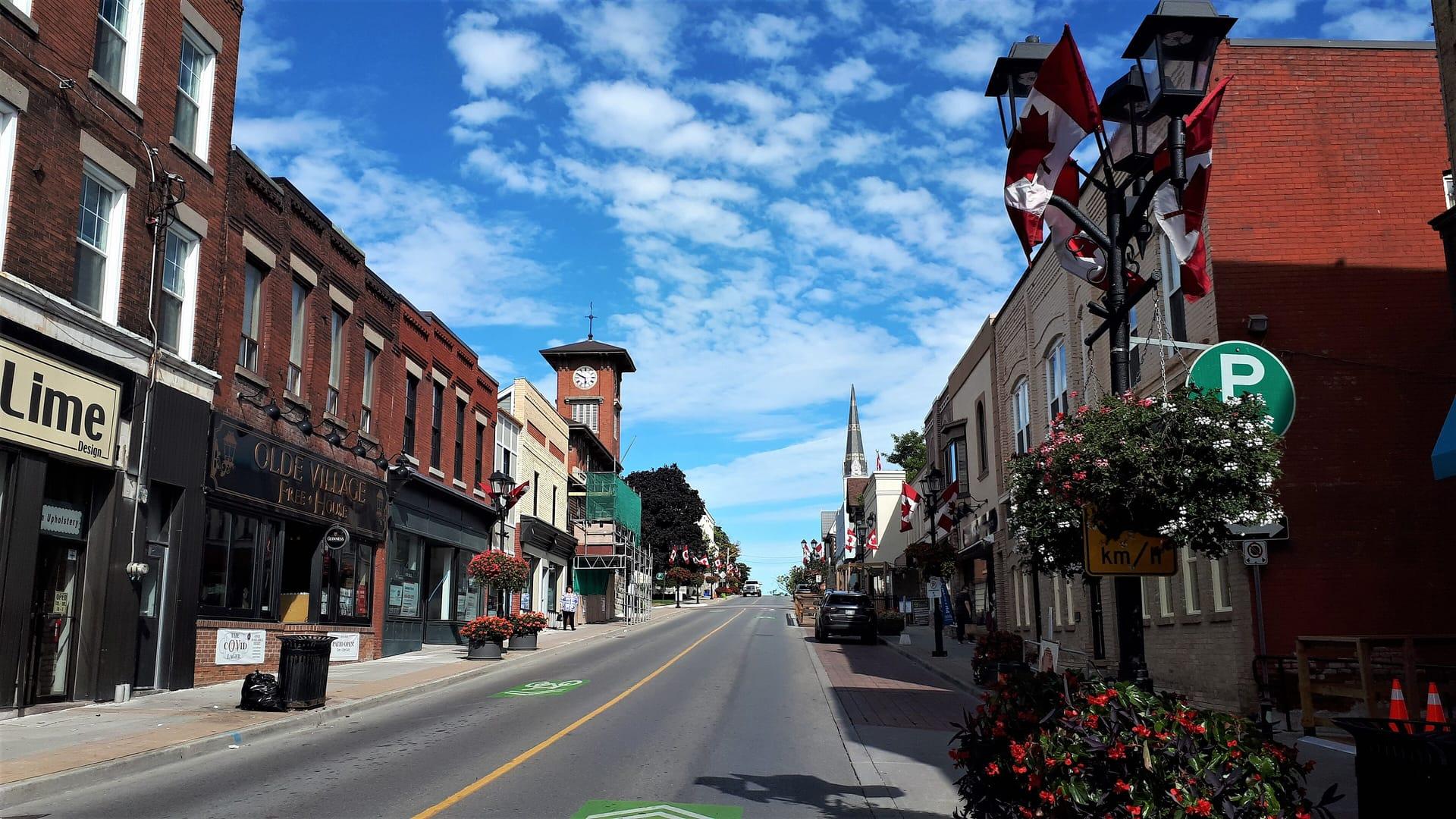 Brick storefronts and flower baskets along Main Street in Newmarket